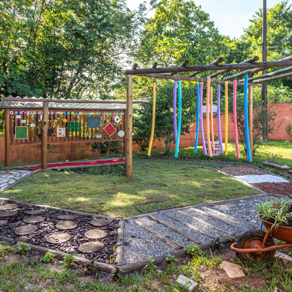 Jardim sensorial infantil seguro com plantas não tóxicas e elementos lúdicos ao ar livre